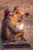 Two male bedouins sitting and smoking in the desert of Wadi Rum. WÄdÄ« Ramm, also WÄdÄ« al-Ramm), known also as the Valley of the Moon (Arabic: ÙØ§Ø¯Ù Ø§ÙÙÙØ± WÄdÄ« al-Qamar), is a valley cut into the sandstone and granite rock in southern 