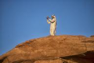 A male bedouin on top of a rock at Wadi Rum. WÄdÄ« Ramm, also WÄdÄ« al-Ramm), known also as the Valley of the Moon (Arabic: ÙØ§Ø¯Ù Ø§ÙÙÙØ± WÄdÄ« al-Qamar), is a valley cut into the sandstone and granite rock in southern Jordan, near the 