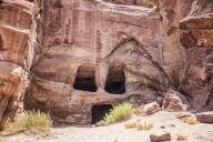 Front of a cave dwelling with carved door and windows in the UNESCO heritage site. Petra, is a historic and archaeological city in southern Jordan. Famous for its rock-cut architecture and water conduit system, Petra is also called the 