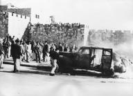 Fourteen dead and many wounded in the latest major guerrilla warfare between Jews and Arabs in Palestine. The fight began in a market square in Jerusalem when a bomb was thrown into the crowd of Arabs from a taxi occupied by Jews disguised as Arabs. 