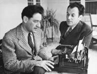 United States: May 6, 1937 Noted playwrights George S. Kaufman and Moss Hart with Kaufman at a typewriter. The two men collaborated on numerous plays.