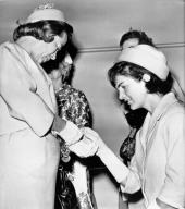Washington, D.C.: May 18, 1961 Mrs. Jacqueline Kennedy inspects a gold bracelet worn by Mrs.Barry Goldwater at a luncheon given for Mrs. Kennedy by wives of the members of Congress.