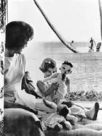 Palm Beach, Florida: February 13, 1961 Jacqueline Kennedy watches her daughter Caroline play with her dolls in the living room of the home in Palm Beach during their last pre-White House vacation.The just inaugurated President Kennedy can be seen ...
