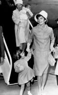 Otis Air Force Base, Massachusetts: June 30, 1961 Jacqueline Kennedy, with daughter Caroline in hand and son John Jr. carried by their nurse, arrives to spend the long July Fourth weekend at Hyannis Port with the President.