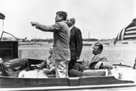 Hyannis Port, Massachusetts: July 8, 1961 President Kennedy points out Hyannis Port landmarks to General Maxwell Taylor, Secretary of State, Dean Rusk, and Secretary of Defense, Robert McNamara aboard the yacht 