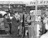 Portland, Oregon: May 25, 1960 Senator John Kennedy of Massachusetts campaigns at the Gateway shopping center two days before the Oregon primary. Members of the Fun-O-Rama Funmakers listen attentively.