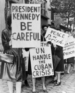 New York, New York: 1962 Group of women from Women Strike for Peace holding placards relating to the Cuban missile crisis and to peace. They were part of a larger group of 800 women strikers for peace on 47th St near the United Nations building.