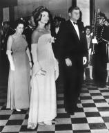 Mexico City, Mexico: June 30, 1962 President and Mrs. Kennedy stand at attention as the national anthems of Mexico and the United States are played at a formal reception in Mexico City. Mrs. Kennedy is wearing a crepe chiffon gown designed by Oleg ...