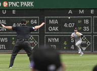 Colorado Rockies outfielder Sean Bouchard (12) chases the ball after it bounces off the left field wall giving Pittsburgh Pirates first base Rowdy Tellez a double in the sixth inning against the Colorado Rockies at PNC Park on Sunday May 5, 2024 in Pittsburgh. Photo by Archie Carpenter