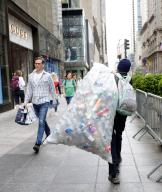 A person carries a clear plastic bag of recyclable cans and bottles on the Fifth Avenue sidewalk in New York City on Thursday May 9, 2024. Photo by John Angelillo