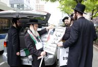 Pro-Palestine Orthodox Jewish Israelis load posters into a car after a pro-Palestine rally in New York City on Thursday, May 9, 2024. Photo by John Angelillo