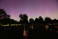 The Northern Lights (Aurora Borealis) are seen over the American flags resting in a cemetary in Wadsworth, Ohio Friday May, 10, 2024. Photo by Aaron Josefczyk