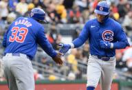 Chicago Cubs second base Nico Hoerner (2) celebrates his home run with Chicago Cubs third base coach Willie Harris (33) against the Pittsburgh Pirates in the fourth inning at PNC Park on Saturday May 11, 2024 in Pittsburgh. Photo by Archie Carpenter