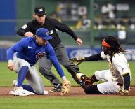 Pittsburgh Pirates shortstop Oneil Cruz (15) is safe at second for a double ahead of the tag from Chicago Cubs second base Nico Hoerner (2) In the fifth inning at PNC Park on Saturday May 11, 2024 in Pittsburgh. Photo by Archie Carpenter