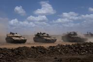Israeli Merkava tanks and an Armored Personnel Carrier (APC) pull into a front line staging area in southern Israel near the border with the Gaza Strip on May 13, 2024. Israel is continuing its limited offensive in the Rafiah area of the southern Gaza Strip. Photo by Jim Hollander