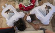 The mother (L) of Sergeant Oriya Yaakov, 20, who was killed in fighting in the Gaza Strip, mourns over his grave in Ashkelon Cemetery as Israel marks Remembrance Day on May 13, 2024. Sergeant Yaakov was killed on his birthday according to the Hebrew calendar. Photo by Jim Hollander