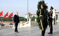 Russian President Vladimir Putin lays a wreath at the Monument to the People