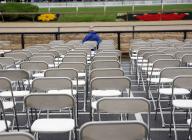 A lone racing fan sits in the grandstand prior to the 149th running of the Preakness Stakes at Pimlico Race Course on Saturday, May 18, 2024 in Baltimore, Maryland. Photo by Mark Abraham