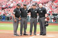 Major League umpire (L to R) Las Diaz, Erich Bacchus, Charlie Ramos and Mike Estabrook gather at home plate for a photograph before the Baltimore Orioles - St. Louis Cardinals baseball game at Busch Stadium in St. Louis on Tuesday, May 21, 2024. Photo by Bill Greenblatt