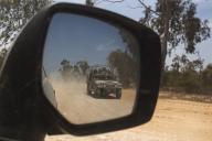 An Israeli army Humvee with soldiers seen in a rear view mirror inside southern Israel near the border with the Gaza Strip on May 22, 2024. On the day when Spain, Ireland and Norway announced they would recognize a Palestinian state next week Israel reports three of its soldiers were killed in fighting Hamas in the northern Gaza Strip. Photo by Jim Hollander