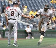 San Francisco Giants outfielder Heliot Ramos (17) celebrates with San Francisco Giants third base coach Matt Williams (9) following his solo homer in the fourth inning against the Pittsburgh Pirates at PNC Park on Thursday May 23, 2024 in Pittsburgh. Photo by Archie Carpenter