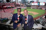 St. Louis Cardinals broadcasters Chip Caray (L) and Joe Buck prepare for a special broadcast of the Chicago Cubs - St. Louis Cardinals baseball game at Busch Stadium in St. Louis on Friday, May 24, 2024. Caray is wearing similar glasses his grandfather Harry wore. Caray
