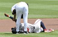 Atlanta Braves outfielder Ronald Acuña Jr. (13) falls to the infield in pain In the first inning before being tagged out by Pittsburgh Pirates pitcher Martín Pérez (54) at PNC Park on Sunday May 26, 2024 in Pittsburgh. Photo by Archie Carpenter