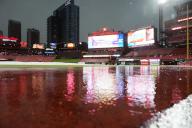 A rain soaked Busch Stadium warning track, a result of strong storms in the area, delay the start of the Chicago Cubs- St. Louis Cardinals baseball game at Busch Stadium in St. Louis on Sunday, May 26, 2024. Photo by Bill Greenblatt