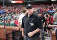 Umpire crew chief Todd Tichenor leads his crew onto the playing field at Busch Stadium for a game between the Chicago Cubs and the St. Louis Cardinals, following a two hour rain delay in St. Louis on Sunday, May 26, 2024. Photo by Bill Greenblatt