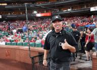 Third base umpire Cory Blaser gives a thumbs up as he enters the playing field at Busch Stadium for a game between the Chicago Cubs and the St. Louis Cardinals, following a two hour rain delay in St. Louis on Sunday, May 26, 2024. Photo by Bill Greenblatt
