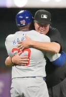 Third base umpire Cory Blaser greets Chicago Cubs third base coach Willie Harris as the game begins against the St. Louis Cardinals at Busch Stadium in St. Louis on Sunday, May 26, 2024. Photo by Bill Greenblatt