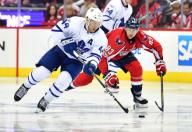 Toronto Maple Leafs defenseman Morgan Rielly (44) and Washington Capitals center Jay Beagle (83) fight for the puck in the third period of game 5 of the Eastern Conference Quarterfinals at the Verizon Center in Washington, D.C. on April 21, 2017. ...