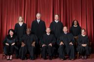 In photo released today, Tuesday, October 18, 2022, the formal group photograph of the Supreme Court as it has been comprised on June 30, 2022, after Justice Ketanji Brown Jackson joined the Court. The Justices are posed in front of red velvet drapes and arranged by seniority, with five seated and four standing. Seated from left are Justices Sonia Sotomayor, Clarence Thomas, Chief Justice John G. Roberts, Jr., and Justices Samuel A. Alito and Elena Kagan. Standing from left are Justices Amy Coney Barrett, Neil M. Gorsuch, Brett M. Kavanaugh, and Ketanji Brown Jackson. Photo by Fred Schilling, Collection of the Supreme Court of the United States 