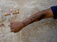 A Christian pilgrim shows his tattoo on the Via Dolorosa, the Way of the Cross, in the Old City of Jerusalem on Good Friday, March 29, 2024. Photo by Debbie Hill