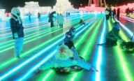 VCG111420024833 HARBIN, CHINA - JANUARY 27: Tourists sitting on a tyre slide on the illuminated road at Harbin Ice and Snow World during the Spring Festival holiday on January 27, 2023 in Harbin, Heilongjiang Province of China. (Photo by VCG\/VCG