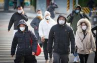 VCG111412281679 BEIJING, CHINA - NOVEMBER 29: People wearing warm clothes walk on the street on November 29, 2022 in Beijing, China. China\'s meteorological authority on Tuesday morning issued an orange alert for a cold wave. (Photo by Jia Tianyong\/China News Service