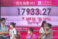 VCG111402512572 HONG KONG, CHINA - SEPTEMBER 23: Pedestrians walk by an electronic screen displaying the numbers for the Hang Seng Index on September 23, 2022 in Hong Kong, China. (Photo by Chen Yongnuo\/China News Service