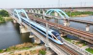 VCG111493444695 LIANYUNGANG, CHINA - APRIL 29: A bullet train runs through Haizhou district prior to May Day holiday on April 29, 2024 in Lianyungang, Jiangsu Province of China. Ahead of this year\'s May Day holiday, which runs from May 1 to 5, train and flight tickets to many popular domestic tourist attractions have already been fully booked. (Photo by Geng Yuhe\/VCG