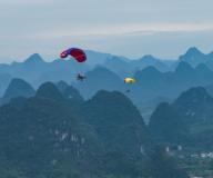 VCG111493892855 GUILIN, CHINA - MAY 01: Tourists enjoy Yangshuo\'s magnificent views during paragliding flights on the first day of May Day holiday on May 1, 2024 in Guilin, Guangxi Zhuang Autonomous Region of China. (Photo by Liu Zheng\/VCG