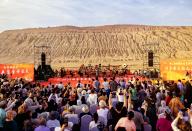 VCG111494365749 TURPAN, CHINA - MAY 04: A symphony concert is performed to entertain tourists at the Flaming Mountains scenic spot during the May Day holiday on May 4, 2024 in Turpan, Xinjiang Uygur Autonomous Region of China. (Photo by Liu Jian\/VCG