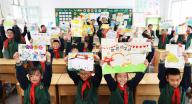 VCG111494769705 LIANYUNGANG, CHINA - MAY 07: Students show their paintings themed with smiley face to welcome the World Smile Day on May 7, 2024 in Lianyungang, Jiangsu Province of China. (Photo by Geng Yuhe\/VCG