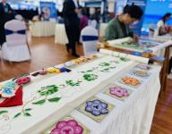 VCG111495045708 GUIYANG, CHINA - MAY 08: Hehuang embroidery products, a kind of traditional Qinghai embroidery, are on display during a vocational skills competition on May 8, 2024 in Guiyang, Guizhou Province of China. (Photo by Sun Rui\/China News Service\/VCG
