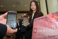 VCG111496652277 HONG KONG, CHINA - MAY 17: Staff members of the Industrial and Commercial Bank of China (ICBC) involved in the cross-boundary e-CNY pilot program display the e-CNY wallets on May 17, 2024 in Hong Kong, China. Hong Kong will facilitate the creation and the use of e-CNY (digital yuan) wallets in the latest progress of collaboration between the Hong Kong Monetary Authority (HKMA) and the People\'s Bank of China to expand an e-CNY pilot for cross-boundary payments, the HKMA said on May 17. (Photo by Chen Yongnuo\/China News Service\/VCG