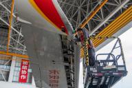 VCG111496660539 HAIKOU, CHINA - MAY 17: An engineer repairs an airplane at a hangar of Hainan Free Trade Port\'s one-stop aircraft maintenance base on May 17, 2024 in Haikou, Hainan Province of China. (Photo by Yuan Chen\/VCG