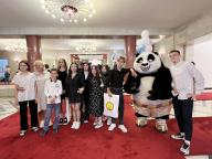 VCG111499414248 MOSCOW, CHINA - MAY 31: Teenagers and parents pose for a group photo with a staff member dressed as a giant panda during a reception celebrating International Children\'s Day at the Chinese Embassy in Russia on May 31, 2024 in Moscow, Russia. (Photo by Tian Bing\/China News Service\/VCG