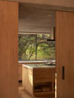 View towards kitchen with picture window. Casa Terreno, n/a, Mexico. Architect: Fernanda Canales, 2018