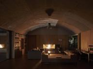 Atmospheric view of living area at night. Casa Terreno, n/a, Mexico. Architect: Fernanda Canales, 2018