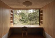 Study with large window view to garden. Casa Terreno, n/a, Mexico. Architect: Fernanda Canales, 2018