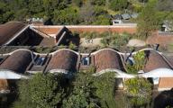 Aerial view of building complex and context. Casa Terreno, n/a, Mexico. Architect: Fernanda Canales, 2018