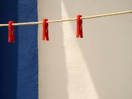 Clothespins hanging on empty clothesline